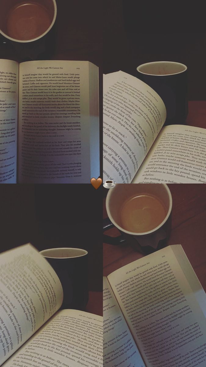 an open book sitting on top of a wooden table next to two cups of coffee