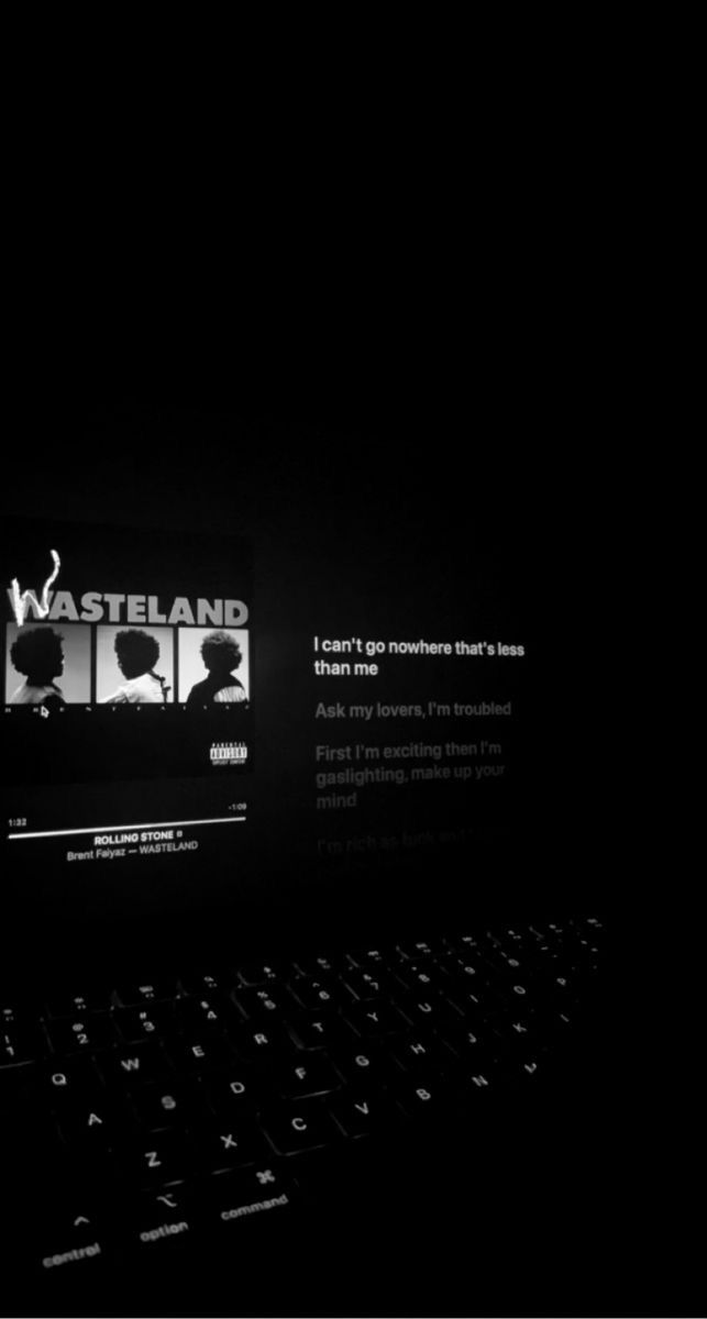 a black and white photo of a laptop computer with the screen lit up at night