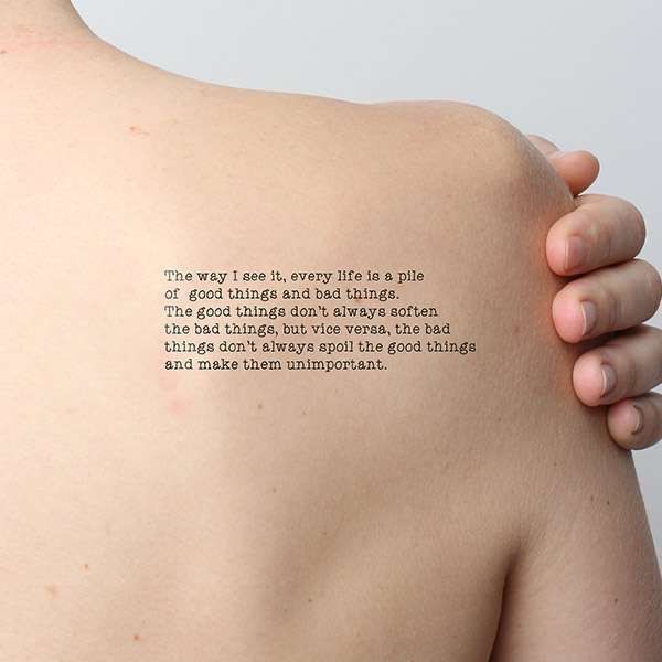 the back of a woman's shoulder with a poem written on it