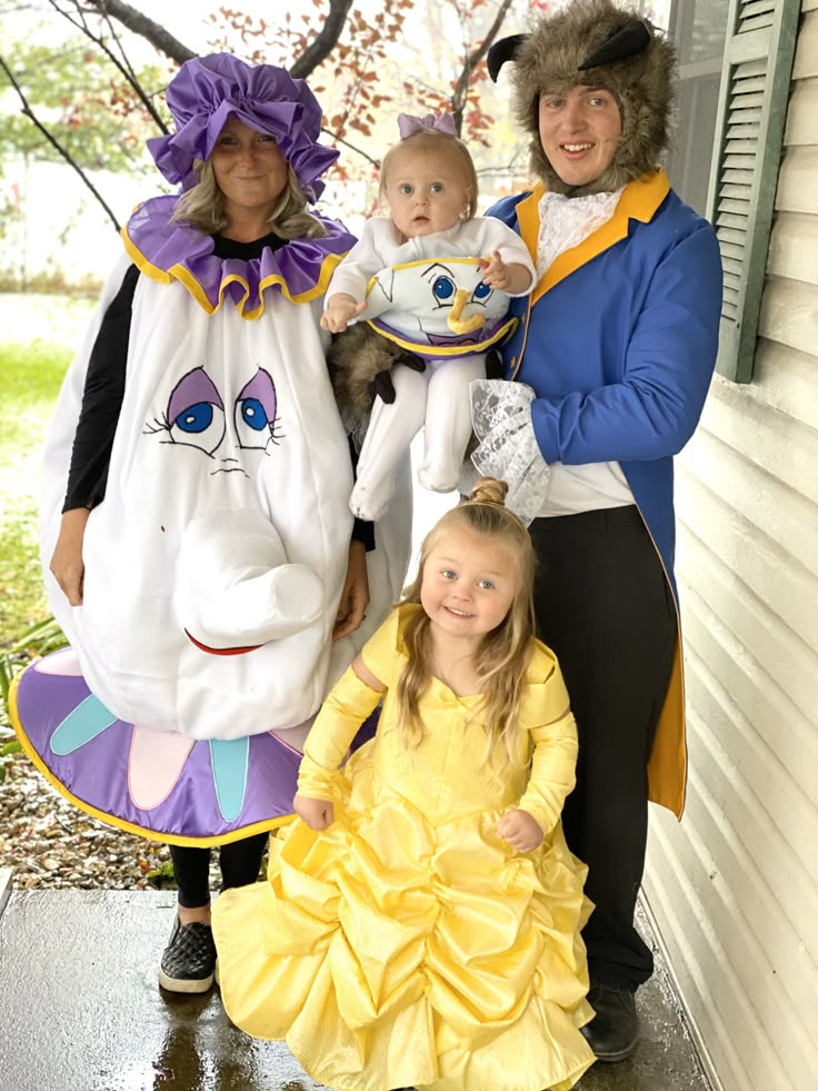 three adults and two children dressed up in costumes