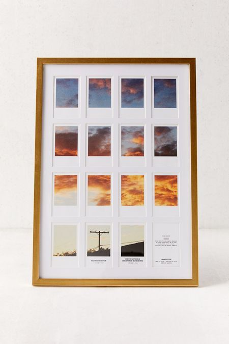 a wooden frame with multiple pictures in it