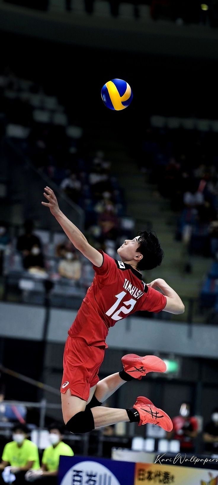 a man jumping in the air to catch a volleyball