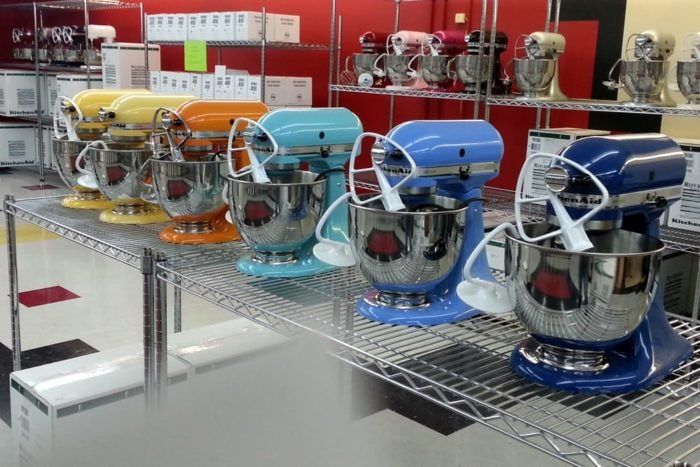 there are many mixers on the shelves in this store, all different colors and sizes