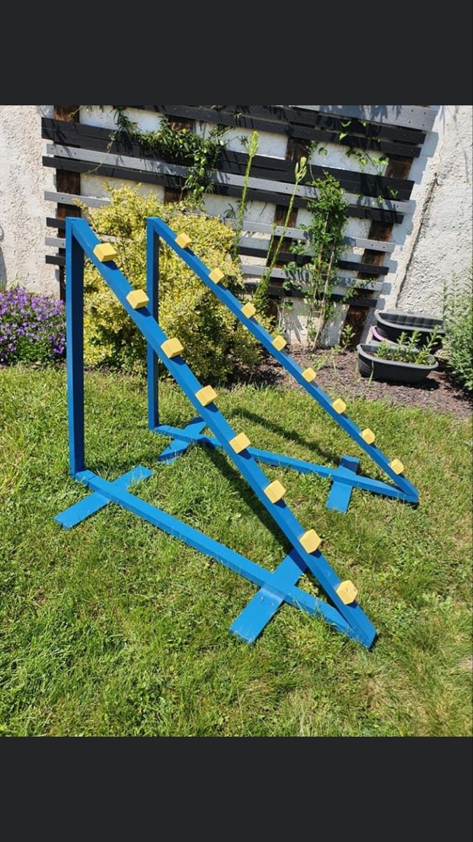 an upside down blue metal object in the grass