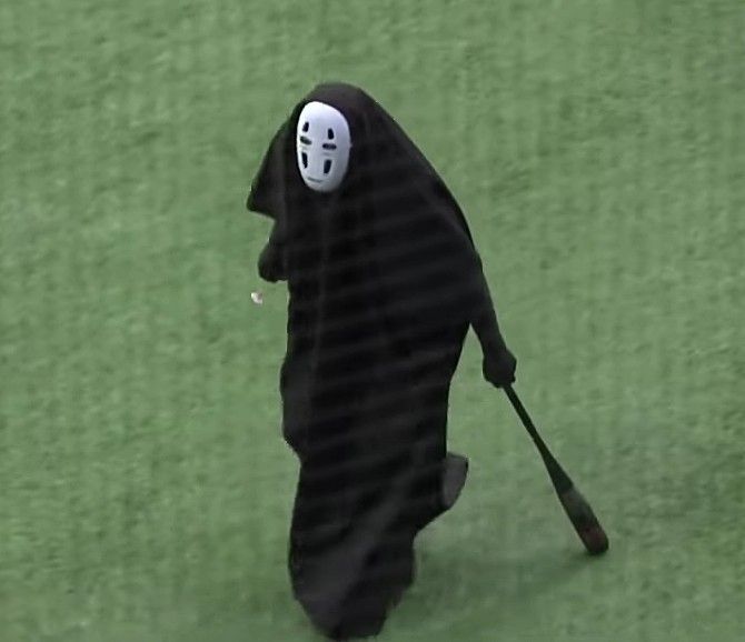 a person in a spirited costume holding a baseball bat