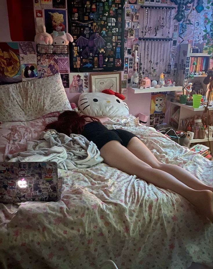 a woman laying on top of a bed in a bedroom