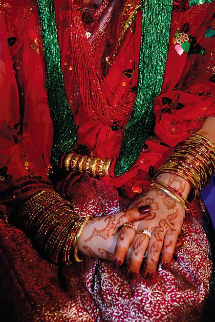 a close up of a person with henna on their hands