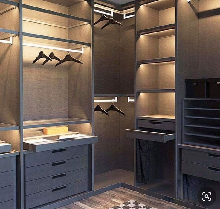 an empty walk in closet with drawers and lights on the ceiling is lit by recessed lighting