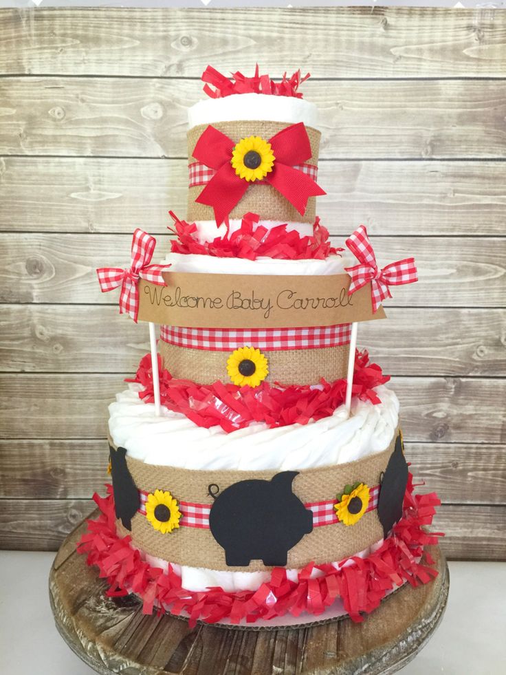 a three tiered cake is decorated with red and white ruffles, sunflowers, and a welcome baby sign