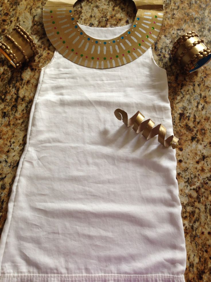 a white dress with gold accents on it