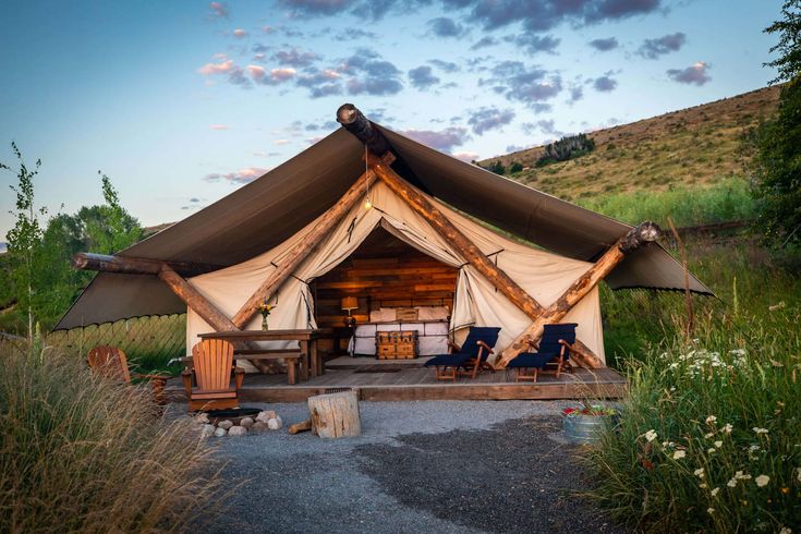 a tent set up in the middle of a field