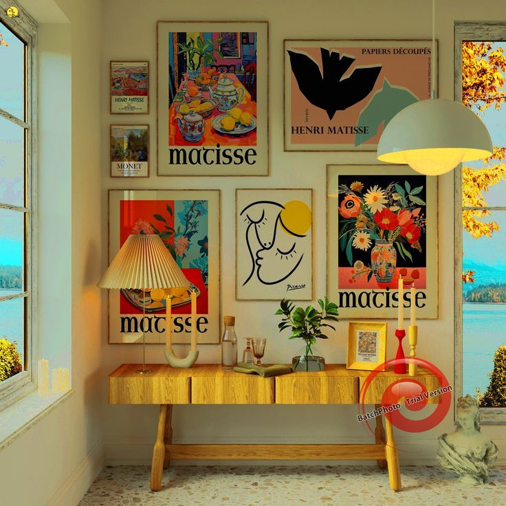 a room with posters on the wall and a table in front of a large window