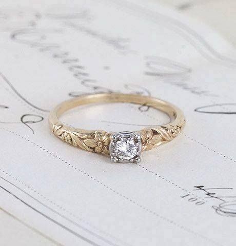 a diamond ring sitting on top of a piece of paper