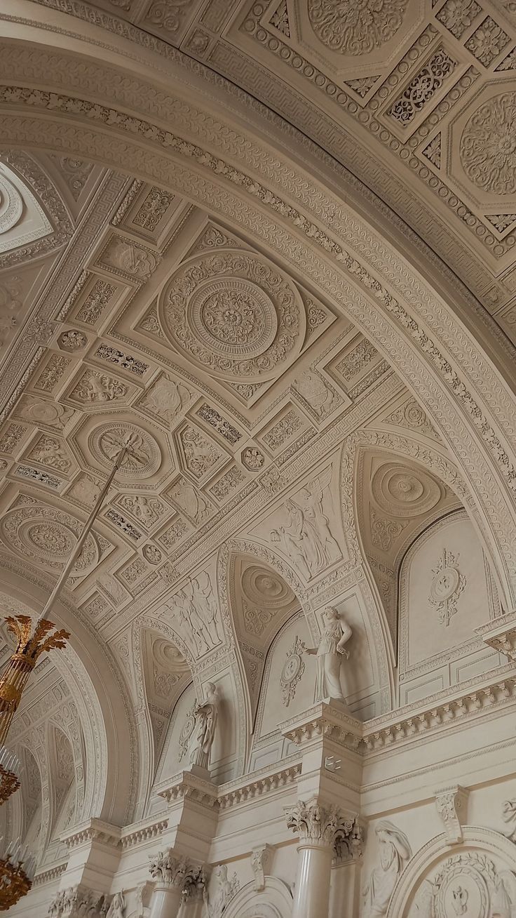 an ornate ceiling with chandeliers and sculptures