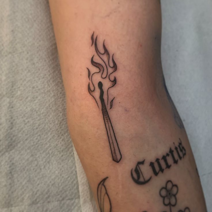 a person with a tattoo on their leg that reads, currus and has a spoon in it