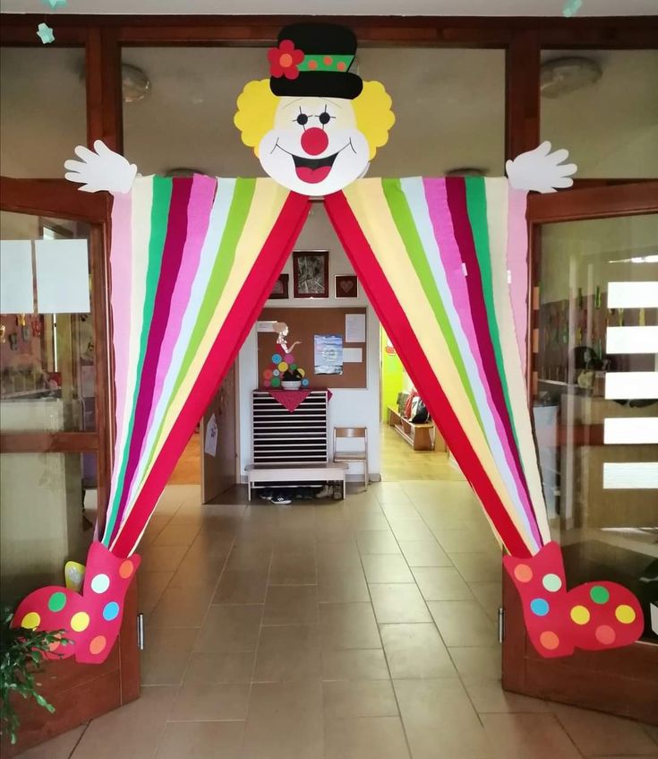 an entrance to a building with a large clown face on the front and side of it