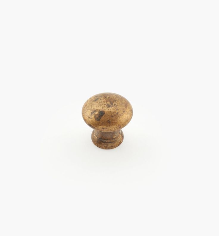 an antique brass knob on a white background