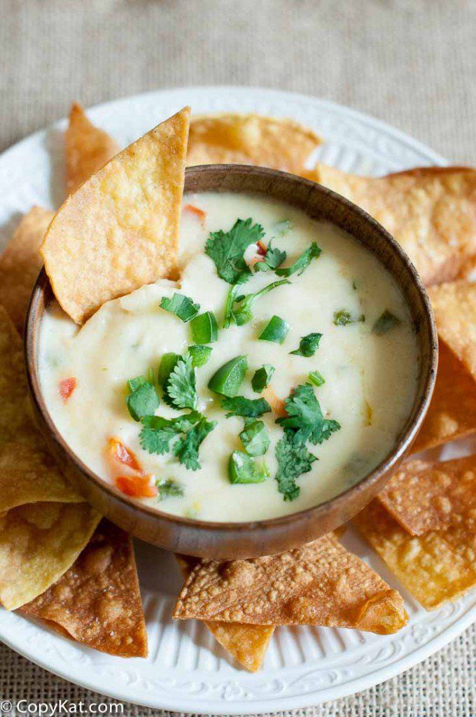 a white plate topped with chips and dip