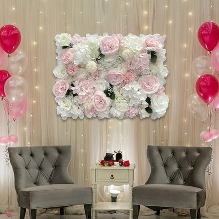 two gray chairs sitting in front of a wall with balloons and flowers on the walls