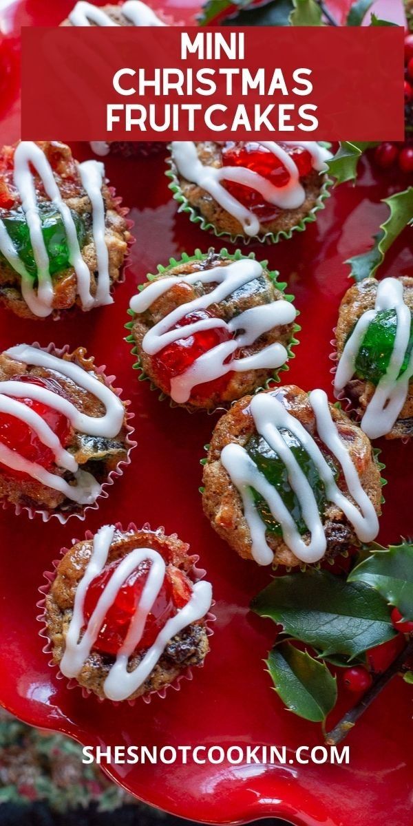 mini christmas fruitcakes on a red plate with white icing and holly leaves