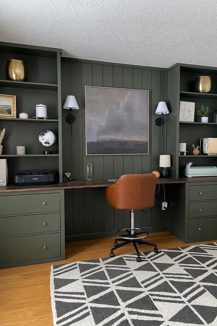 an office with green walls and wooden flooring, built in shelving unit units