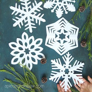 someone is making snowflakes out of paper and pine cones