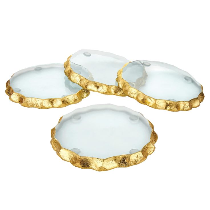 three white and gold plates on a white background