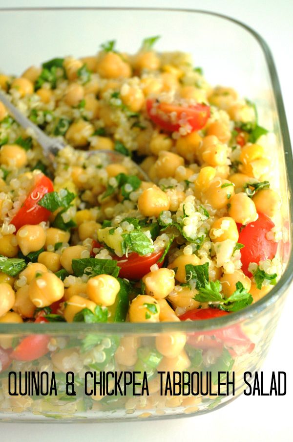 a salad with chickpeas and tomatoes in a glass dish