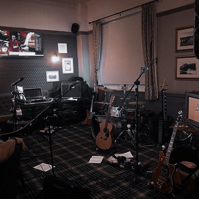 a room with guitars and other musical equipment