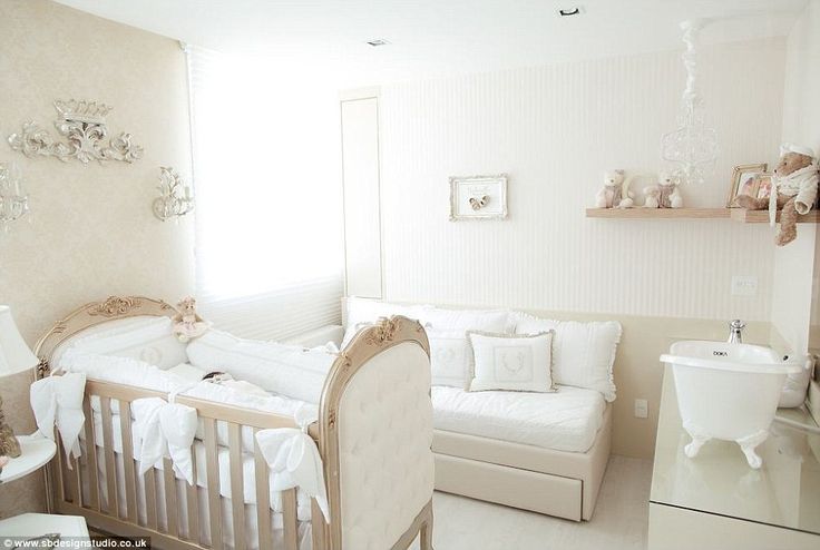 a baby's room with white furniture and decor