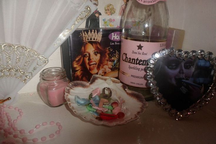 a table topped with lots of different items and decor on top of it's shelf