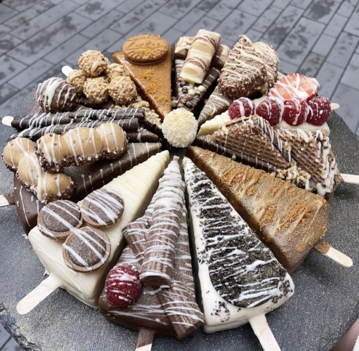 a platter filled with lots of different types of desserts on top of each other