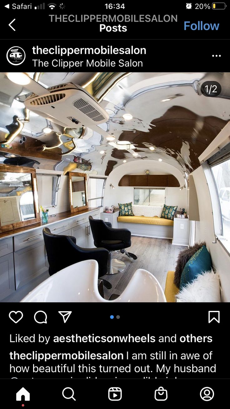 the inside of a bus with mirrors and furniture on it's sides, including two black chairs