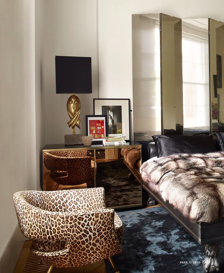 a bedroom with leopard print furniture and mirrors