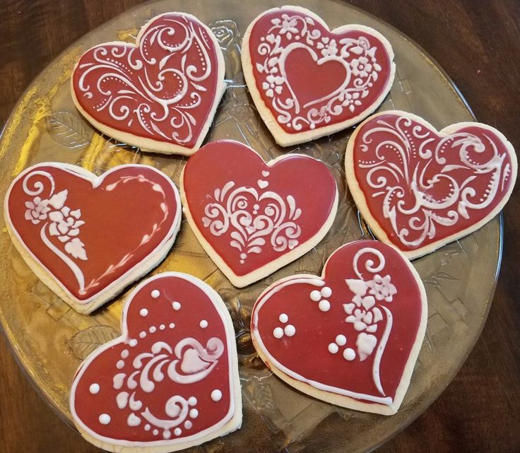 decorated heart shaped cookies on a plate