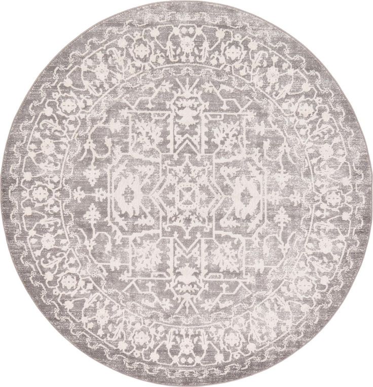 a round rug with an ornate design in grey and white on a white background,