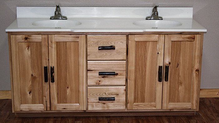 two white sinks sitting on top of a wooden cabinet