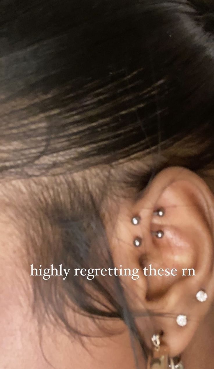 a woman with piercings on her ear and behind the ear is an earring