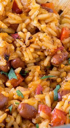 a bowl filled with rice, beans and tomatoes