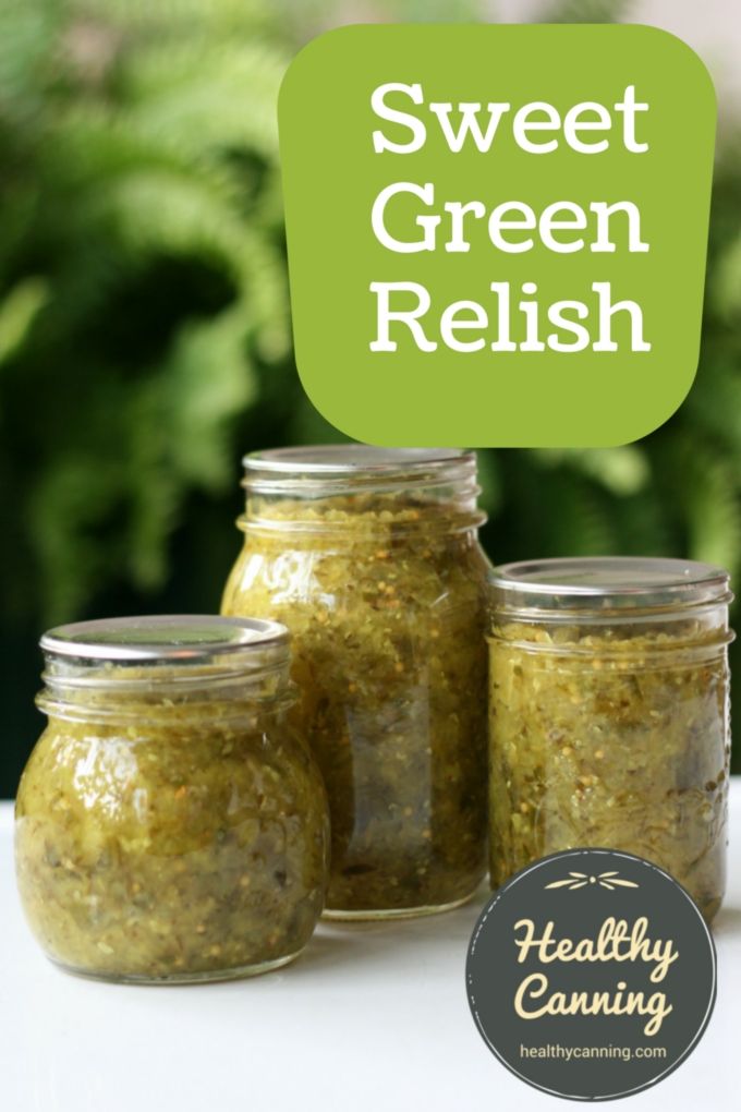 three jars filled with green relish sitting on top of a table