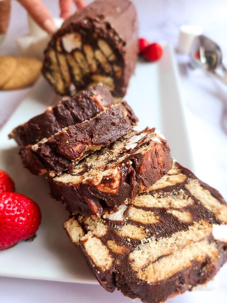 a white plate topped with brownies and strawberries