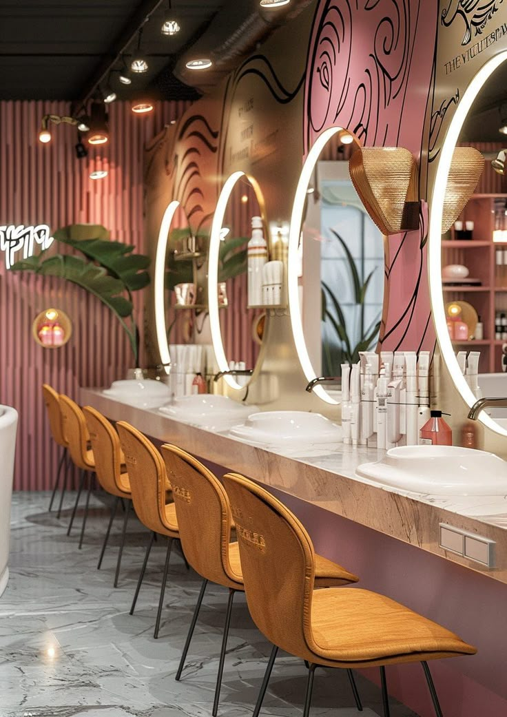 the interior of a modern bar with stools and mirrors on the wall, along with two sinks