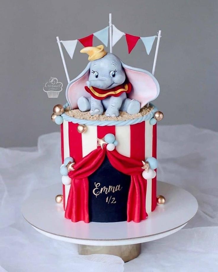 an elephant is sitting on top of a circus tent cake