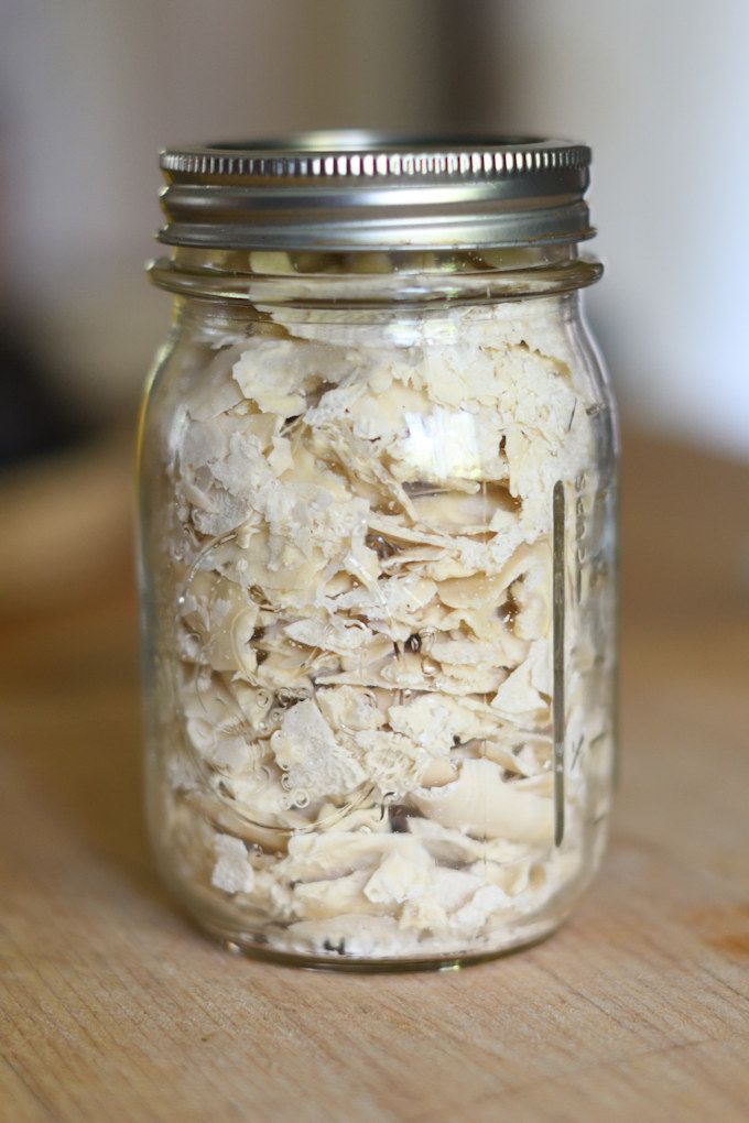 a glass jar filled with food sitting on top of a wooden table