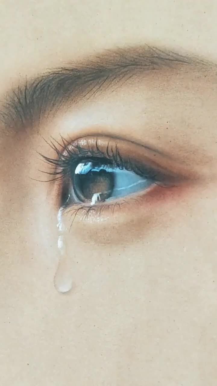 a woman's eye with water dripping from it