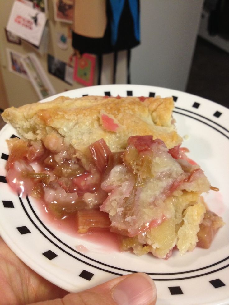 a piece of pie on a white and black plate