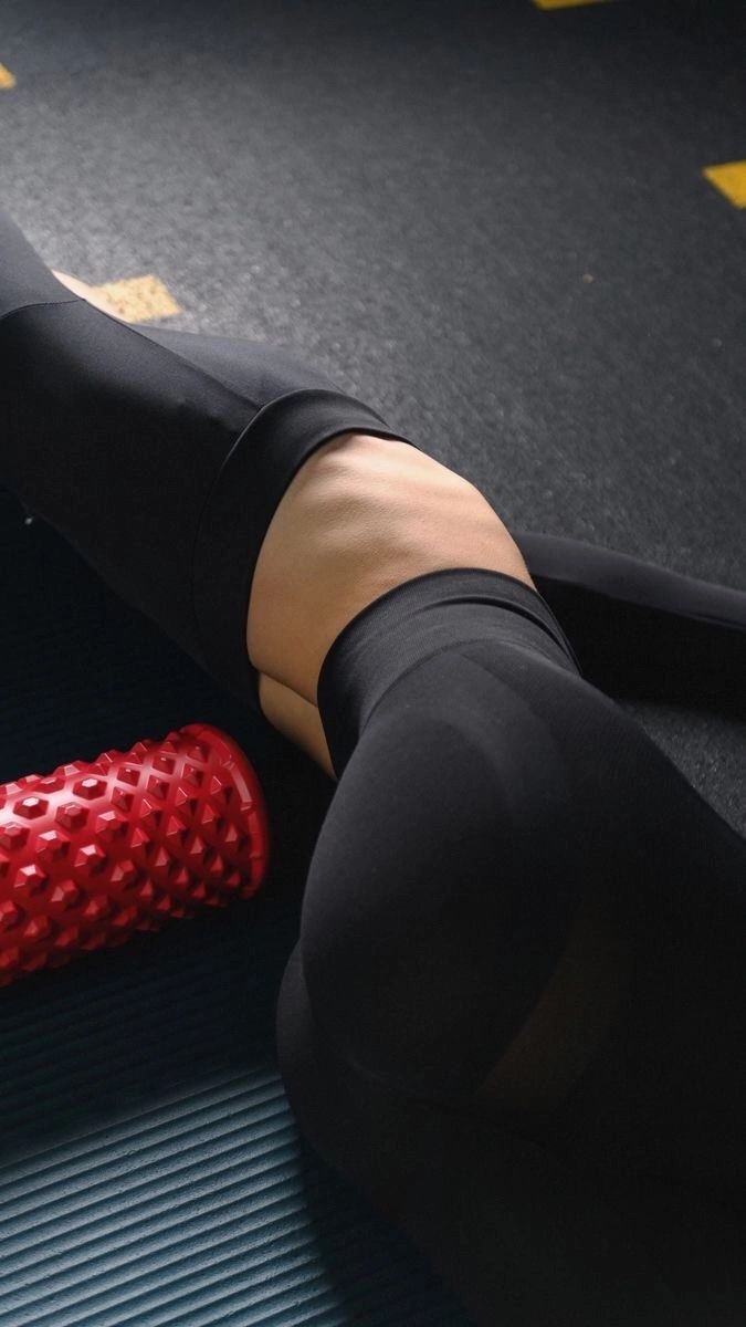 a close up of a person laying on the ground with a red object in their hand