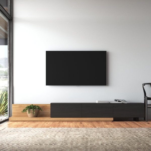 a living room with a large flat screen tv on the wall