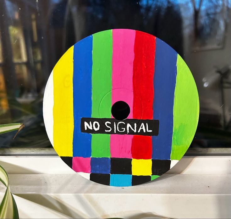 there is a no signal sticker on the window sill in front of a potted plant