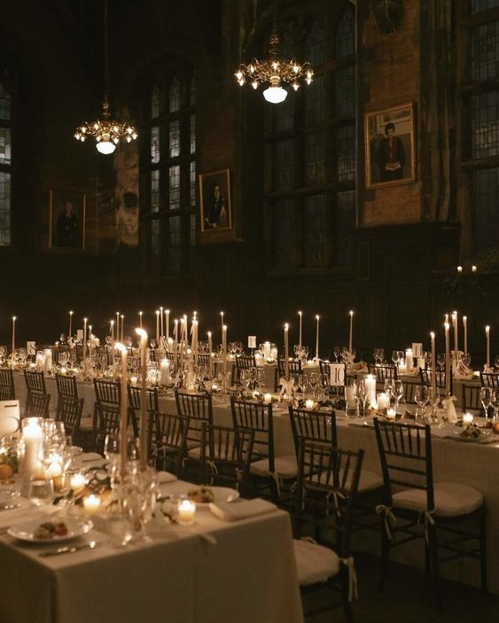 the tables are set up with candles and place settings for an elegant dinner or reception